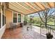 Covered outdoor patio with stone pavers and wrought iron seating at 7276 Brighton Ct, Castle Pines, CO 80108