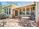 Outdoor patio with retractable awning and wrought iron seating at 7276 Brighton Ct, Castle Pines, CO 80108