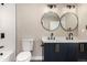 Modern bathroom with double vanity, black faucets, and sleek lighting at 11820 Sherman St, Northglenn, CO 80233