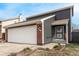 Charming home featuring a two-car garage, red brick accents, and tidy landscaping at 11820 Sherman St, Northglenn, CO 80233