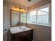 Bathroom featuring vanity with mirror and light fixtures at 17863 Fringed Sage Way, Parker, CO 80134