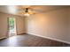 This is a bedroom with hardwood floors, a ceiling fan, and a bright window at 17863 Fringed Sage Way, Parker, CO 80134