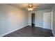 Bedroom featuring hardwood floors, neutral paint, closet and white door at 17863 Fringed Sage Way, Parker, CO 80134