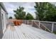 This is an outdoor deck with white wooden planks and a matching railing, featuring a barbecue covered in orange tarp at 17863 Fringed Sage Way, Parker, CO 80134