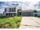 Inviting two-story home with gray siding, black door, and convenient two-car garage at 17863 Fringed Sage Way, Parker, CO 80134