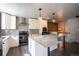 Beautiful kitchen featuring white cabinets, stone counters, and stainless steel appliances at 17863 Fringed Sage Way, Parker, CO 80134