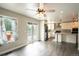 Open-concept space featuring hardwood floors connecting kitchen and living room at 17863 Fringed Sage Way, Parker, CO 80134