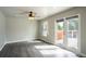 Sunlit living area with hardwood floors and patio access to outdoor deck at 17863 Fringed Sage Way, Parker, CO 80134
