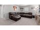 Finished basement area featuring a sectional sofa, window, and neutral carpeting at 23998 E Atlantic Pl, Aurora, CO 80018