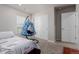 Bedroom featuring a hanging chair, closet and bed with patterned bedding at 23998 E Atlantic Pl, Aurora, CO 80018