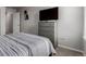 Bedroom featuring a TV, dresser, and comfortable bed with gray and white striped bedding at 23998 E Atlantic Pl, Aurora, CO 80018