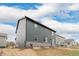 Two-story home with gray siding and stone foundation, viewed from the side exterior at 23998 E Atlantic Pl, Aurora, CO 80018