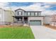 Charming two-story home with a well-manicured lawn and a two-car garage at 23998 E Atlantic Pl, Aurora, CO 80018