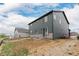 Back exterior view of a two-story home with gray siding and a stone foundation at 23998 E Atlantic Pl, Aurora, CO 80018