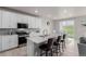 Contemporary eat-in kitchen with an island, stainless steel appliances, and bar stool seating at 23998 E Atlantic Pl, Aurora, CO 80018