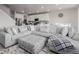 Open-concept living room with large sectional and kitchen at 23998 E Atlantic Pl, Aurora, CO 80018