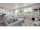 Open-concept living room featuring a comfortable sectional and modern decor at 23998 E Atlantic Pl, Aurora, CO 80018