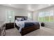Comfortable primary bedroom with a large bed, carpeted floor, and windows with outdoor views at 23998 E Atlantic Pl, Aurora, CO 80018