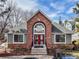 Community clubhouse featuring a brick facade, red doors, and ample parking at 6776 S Ivy St # B5, Centennial, CO 80112