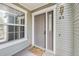 Charming entrance with a gray door, decorative hardware, and a welcoming doormat next to a window at 6776 S Ivy St # B5, Centennial, CO 80112