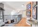 Hallway with sleek hardwood floors, modern metal banister, and framed art on the accent wall at 6776 S Ivy St # B5, Centennial, CO 80112
