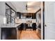 Modern kitchen features dark cabinets, granite countertops, stainless steel appliances, and subway tile backsplash at 6776 S Ivy St # B5, Centennial, CO 80112