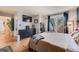 Comfortable main bedroom with balcony access, dresser, mounted TV, and views of the backyard at 6776 S Ivy St # B5, Centennial, CO 80112