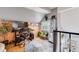 Bright home office with a large desk, black chair, and vibrant round rug atop hardwood floors at 6776 S Ivy St # B5, Centennial, CO 80112