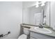Powder room features a modern vanity, neutral countertops, sleek fixtures and tiled floors at 18150 Bolero Dr, Parker, CO 80134