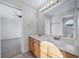 Bathroom with double sinks, wood cabinets, and a large mirror at 18150 Bolero Dr, Parker, CO 80134