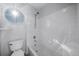 Bathroom featuring a bathtub with a toilet and a porthole window at 18150 Bolero Dr, Parker, CO 80134