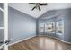 Bedroom with light blue walls, wood floors, bay windows, and ceiling fan for added comfort at 18150 Bolero Dr, Parker, CO 80134