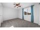 Bedroom with ceiling fan, neutral carpeting, and a window with blue curtains at 18150 Bolero Dr, Parker, CO 80134