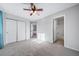 Bright bedroom featuring a closet, ceiling fan, and neutral carpeting at 18150 Bolero Dr, Parker, CO 80134