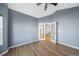 Bedroom boasts wood floors, ceiling fan, and french doors leading to the landing and stairs at 18150 Bolero Dr, Parker, CO 80134