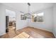 Sunlit dining room with hardwood floors and modern chandelier adjacent to the kitchen at 18150 Bolero Dr, Parker, CO 80134