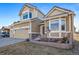 Charming two-story home with a two-car garage, manicured lawn, and lovely landscaping at 18150 Bolero Dr, Parker, CO 80134