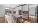 Kitchen with center island, stainless appliances and adjacent sliding doors leading to outdoor space at 18150 Bolero Dr, Parker, CO 80134