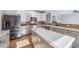 Open kitchen featuring stainless appliances, quartz countertops, and a central island with ample counter space at 18150 Bolero Dr, Parker, CO 80134