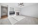 Open living room features built in shelves, gas fireplace, and plush carpeting for added comfort at 18150 Bolero Dr, Parker, CO 80134