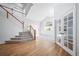 Bright and airy living room with hardwood floors, a staircase, and natural light at 18150 Bolero Dr, Parker, CO 80134