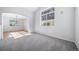 Bright living room features plush carpeting, large windows, and an archway entrance to dining area at 18150 Bolero Dr, Parker, CO 80134