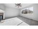 Spacious living room features a fireplace, large windows, ceiling fan and plush neutral carpeting at 18150 Bolero Dr, Parker, CO 80134