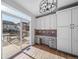 Home office space with built-in desk and cabinetry, plus access to an outdoor deck with sliding doors at 18150 Bolero Dr, Parker, CO 80134