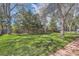 Expansive backyard with mature trees and a large grassy area at 6458 W Clifton Pl, Littleton, CO 80128