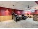 Basement featuring wood paneling, carpet, and a bar with seating at 6458 W Clifton Pl, Littleton, CO 80128