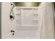 Bathroom showcasing a shower tub combination with a shower head and white tile at 6458 W Clifton Pl, Littleton, CO 80128