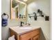 Bathroom with a vanity, framed mirror, and towel rack at 6458 W Clifton Pl, Littleton, CO 80128