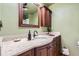 Well-lit bathroom featuring dark wood cabinets and quartz countertops at 6458 W Clifton Pl, Littleton, CO 80128