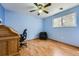 Bright bedroom with hardwood floors, ceiling fan, and a window offering natural light at 6458 W Clifton Pl, Littleton, CO 80128